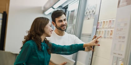 A couple assessing bathroom tiles for a remodel